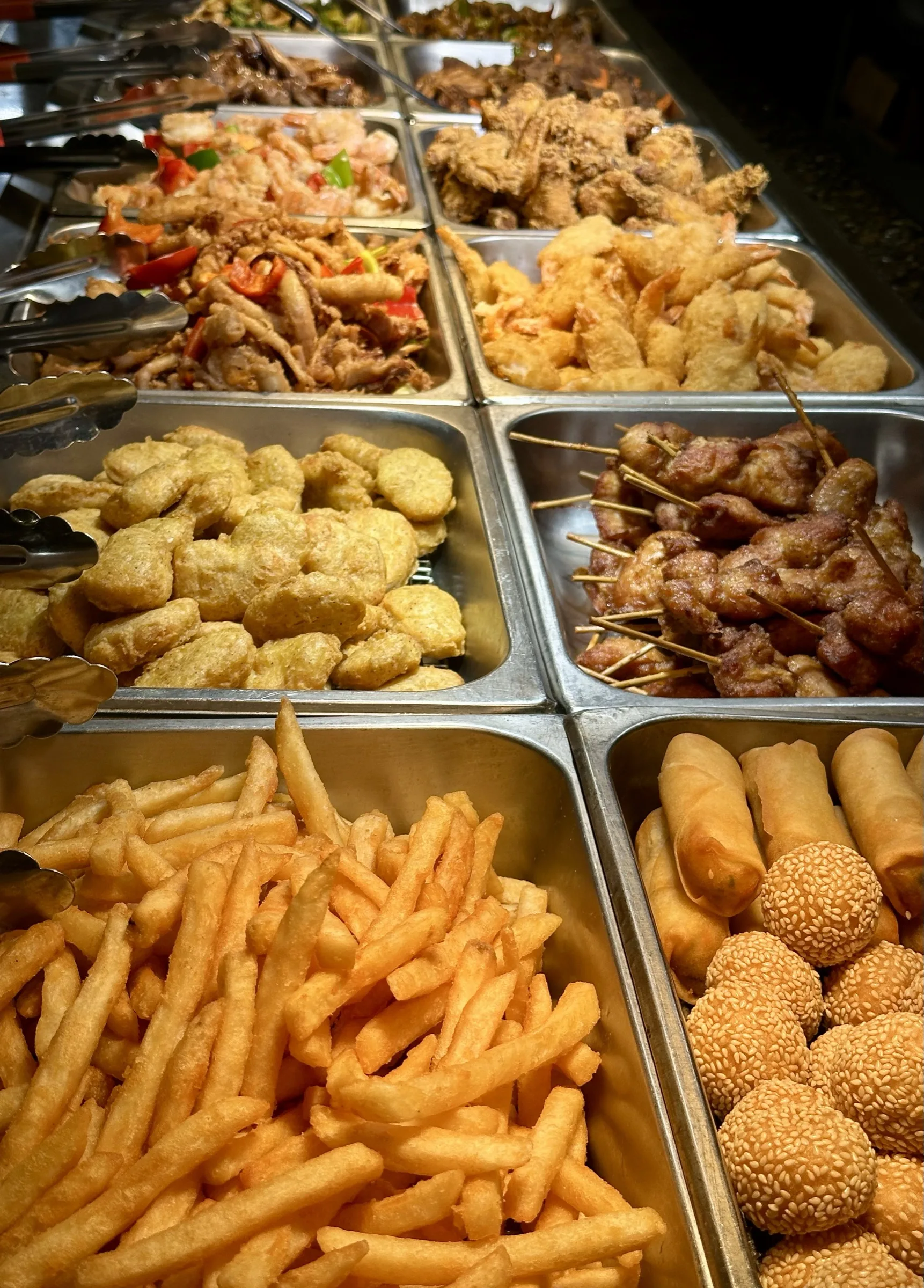 Buffet line with mushroom beef, fried chicken, and stir-fry dishes at Kumo Ultimate, Stamford CT