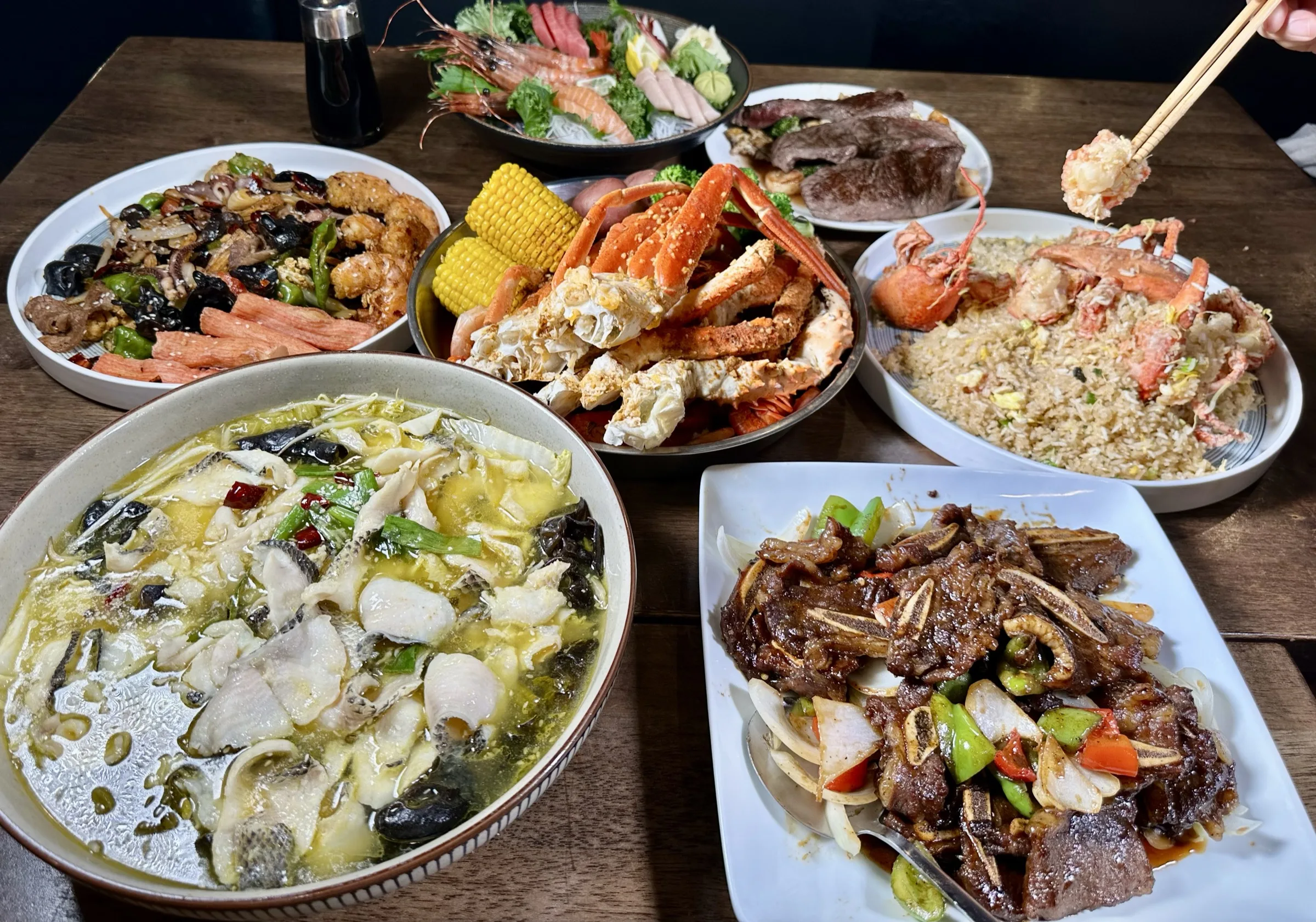 Full table with crab legs, lobster fried rice, fish soup, and hibachi dishes at Kumo Ultimate, Stamford CT