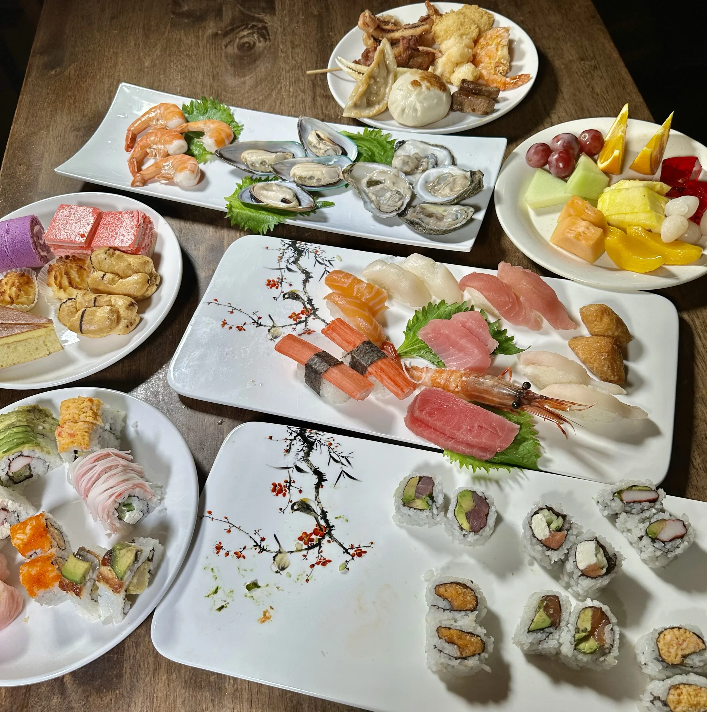 Table spread of sushi plates, oysters, and specialty rolls at Kumo Ultimate, Stamford CT